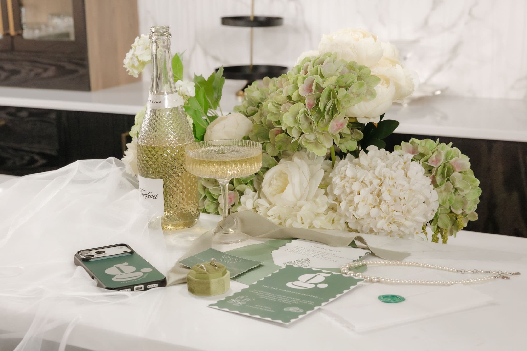 Styled tabletop with florals and the CBG phone case