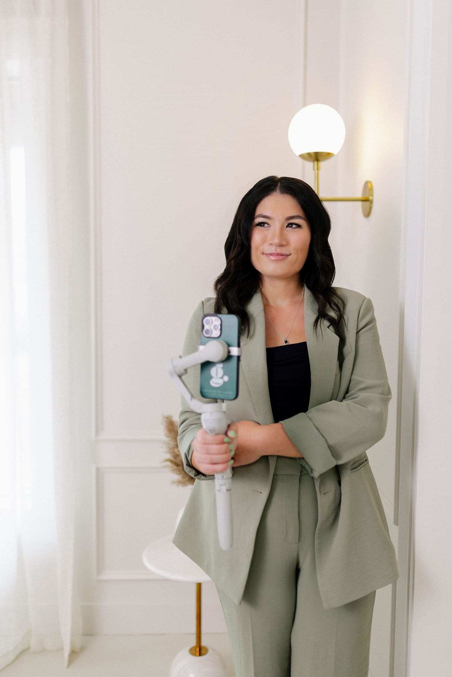 Gabby holding her phone and gimbal in the studio