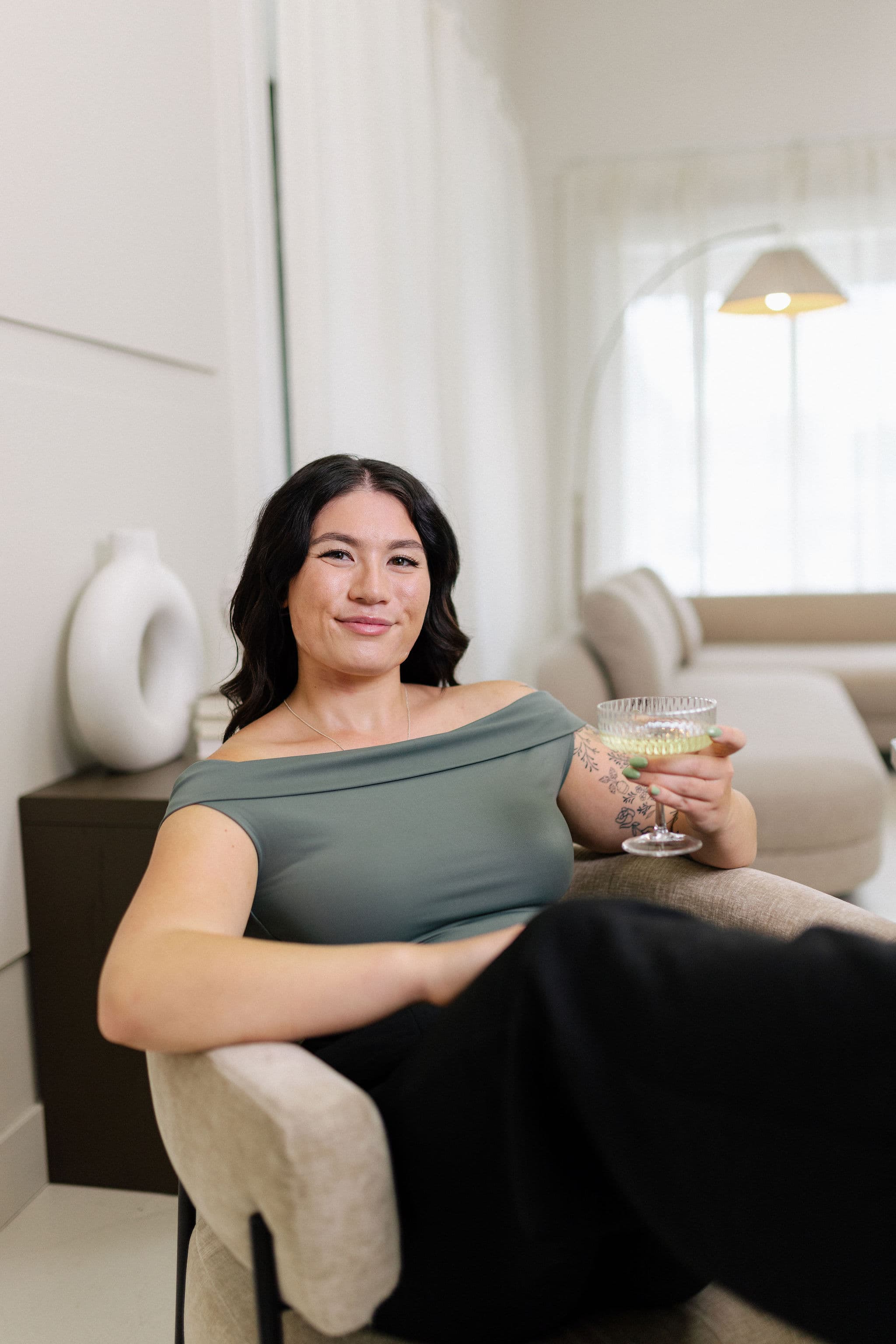 Gabby seated with a celebratory drink in the studio